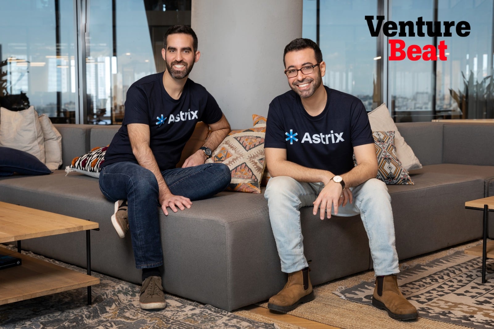 Image: Two men in Atrix t-shirts sit on a modern gray couch. The "Venture Beat" logo is displayed on the wall. Astrix is the leading platform in NHI security, protecting non-human identities with cutting-edge service account management. *Alt text:* Two men wearing Atrix t-shirts sitting on a modern gray couch; the "Venture Beat" logo is visible on the wall.